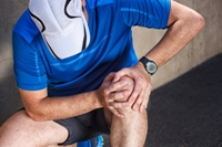 Photo of sportsman with knee pain